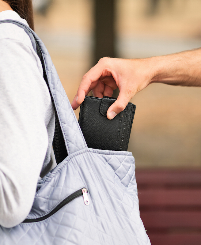 Park crime. Pickpocket thief stealing wallet from woman handbag